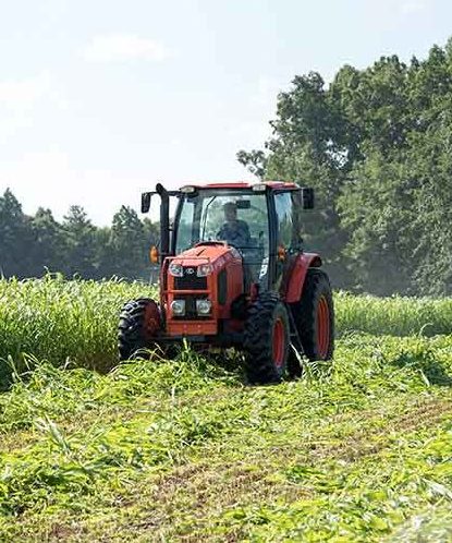 Tractor plowing in a field on a farm 